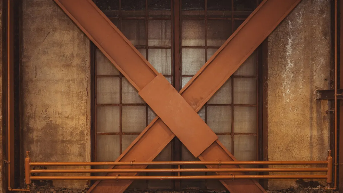 Steel cross-bracing fixed across a wall