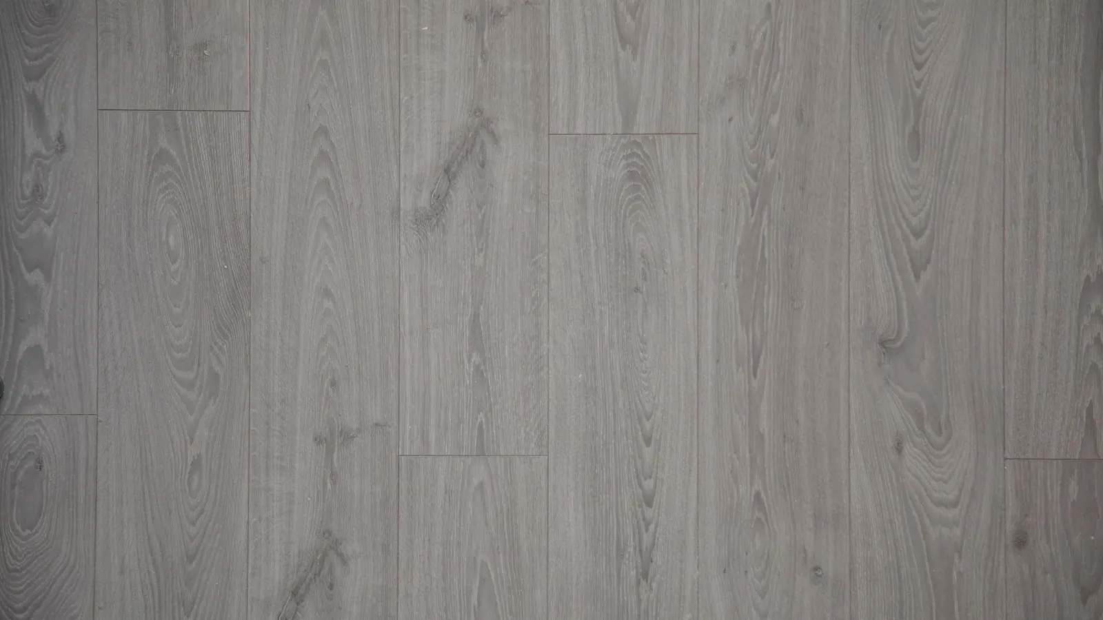 A close-up of pale grey plank flooring