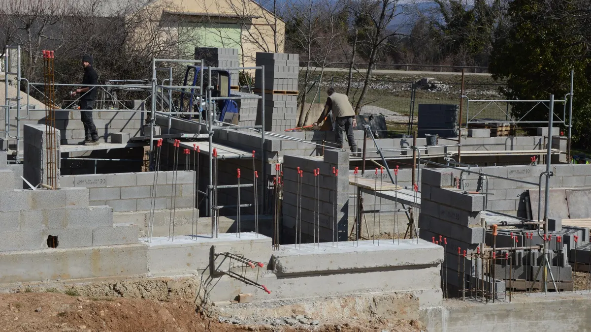 A concrete block foundation under construction on a building site