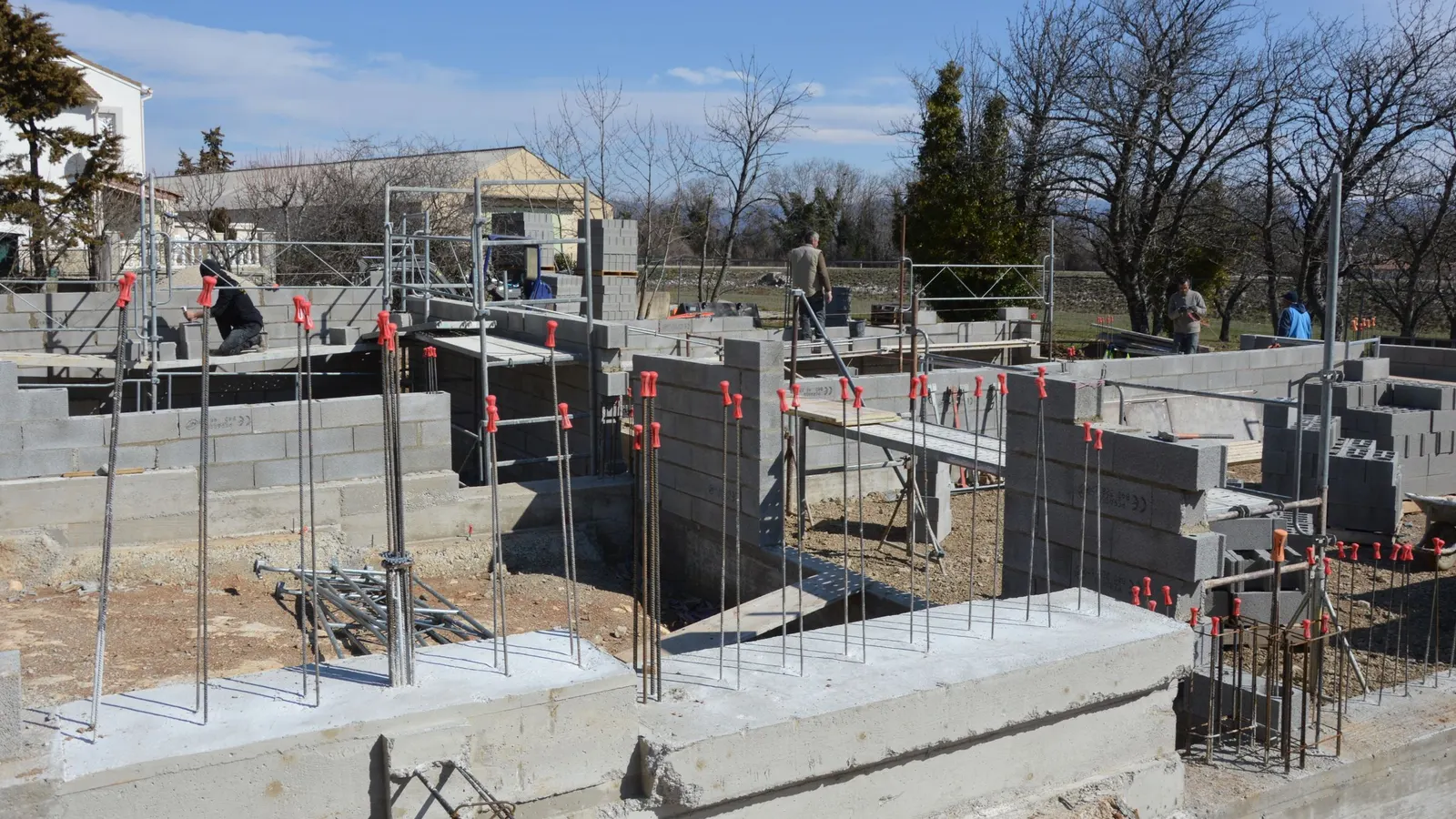 A concrete block foundation being built on a construction site