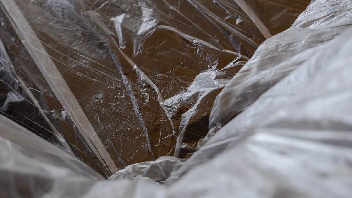 Transparent plastic sheeting draped loosely over a surface