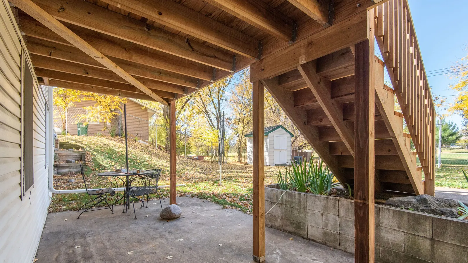 Ground-level space beneath a raised timber deck and steps