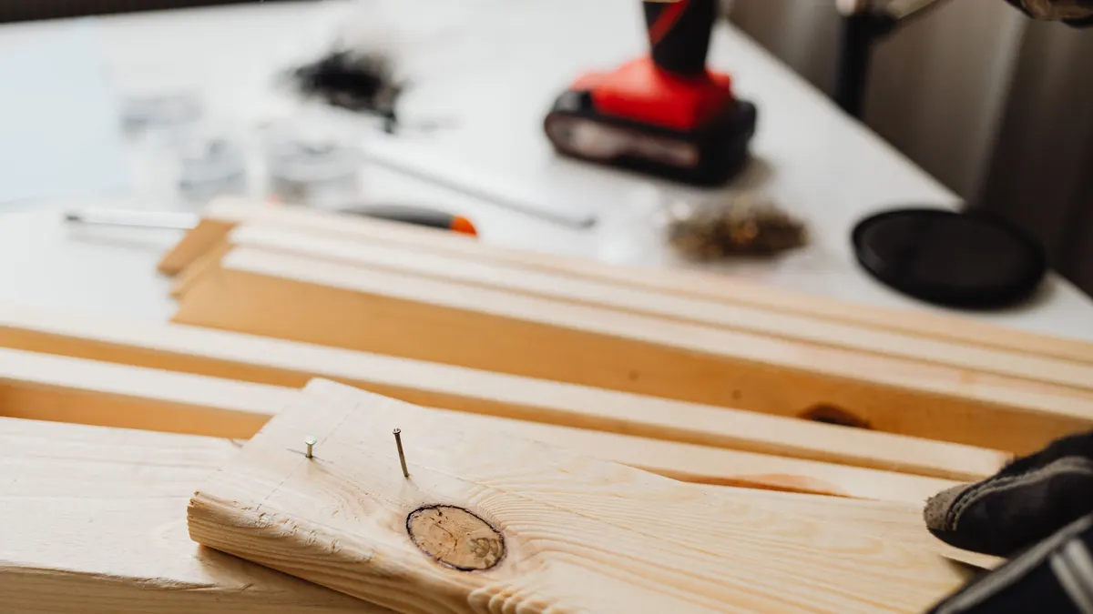 A power drill and wooden planks during woodworking