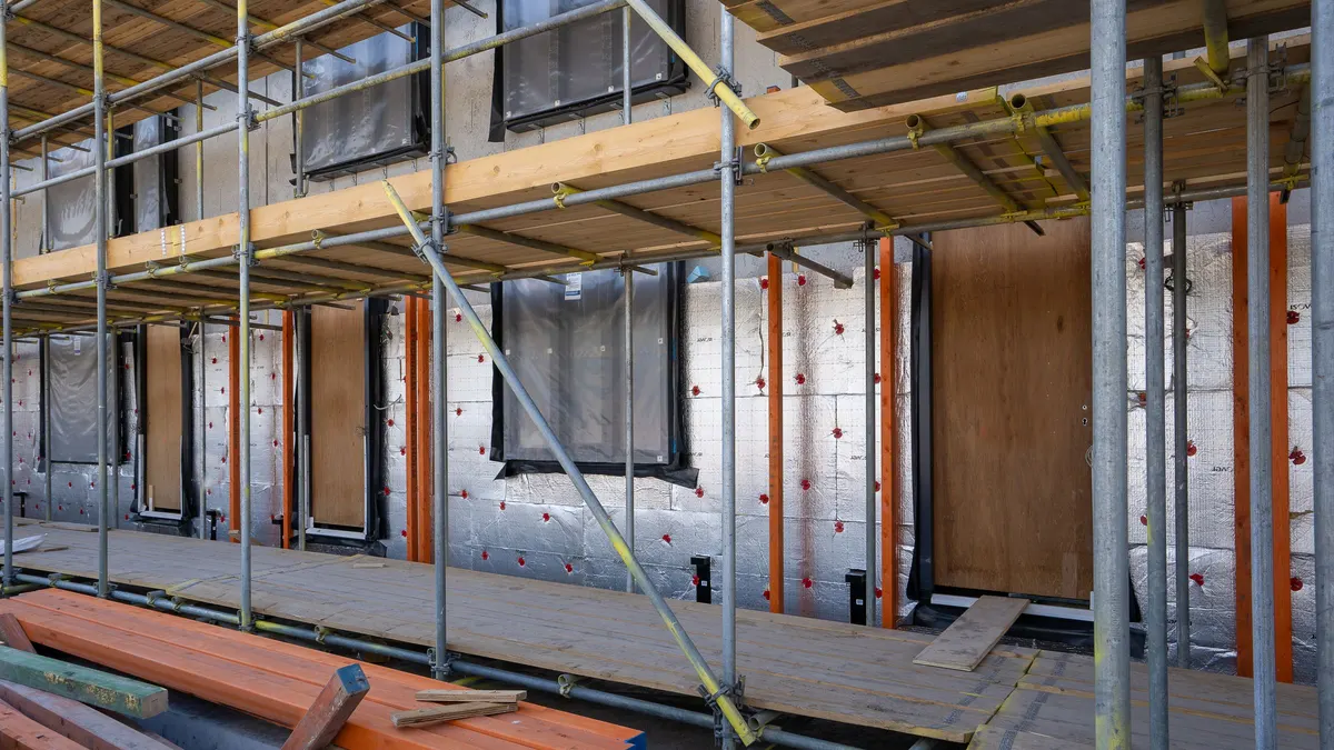 Scaffolding and exposed framing at a residential building under construction