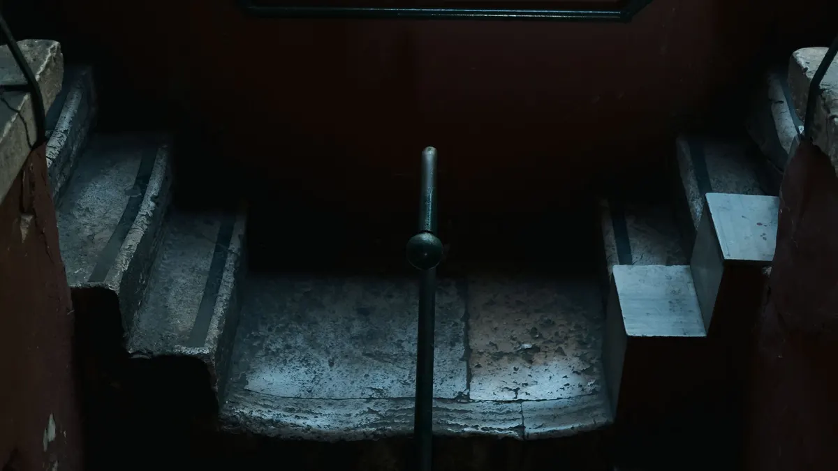 An old stone staircase descending into a dimly lit space