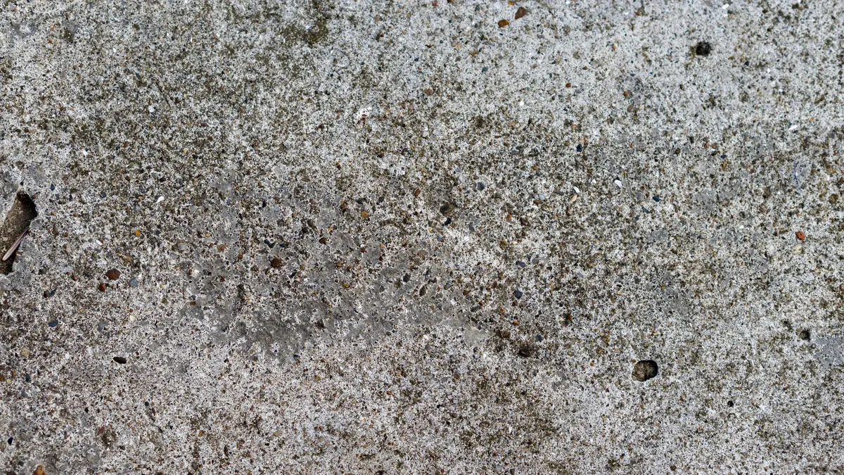 A crack running across a weathered concrete surface